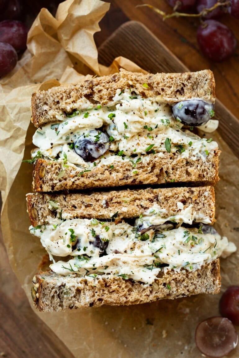 Chicken salad sandwich made with whole wheat bread and creamy herb filling.
