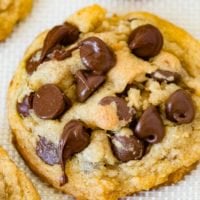 A photo of a chocolate chip pudding cookie covered in chocolate chips.