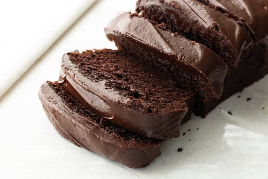 a loaf of moist chocolate pumpkin bread topped with thick chocolate ganache