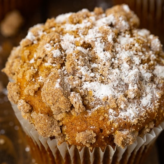 a jumbo pumpkin streusel muffin with a sprinkle of powdered sugar
