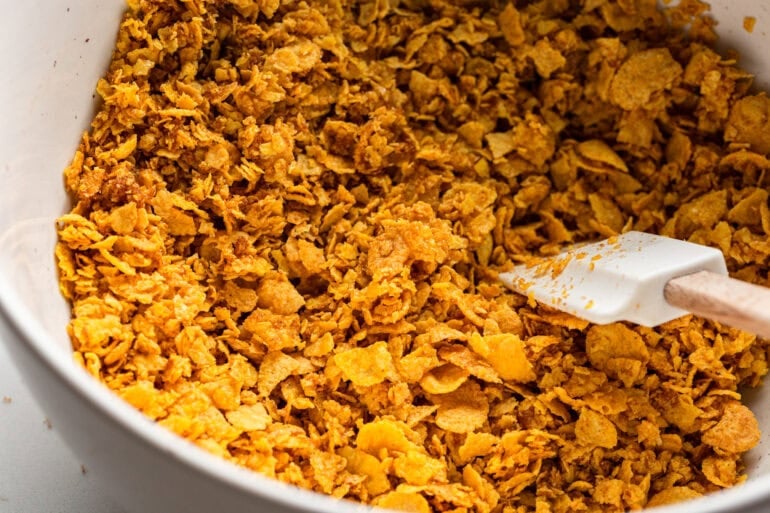 the crunchy topping for french toast sticks being stirred with a rubber spatula