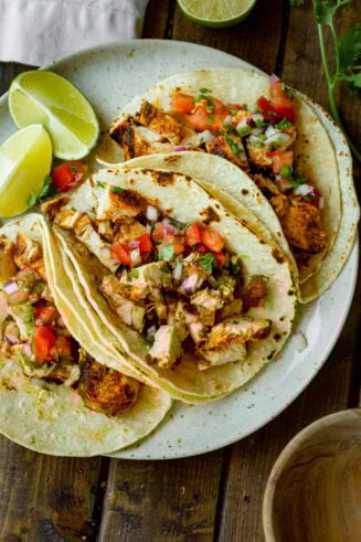 a photo of three grilled chicken tacos in topped with fresh pico de gallo
