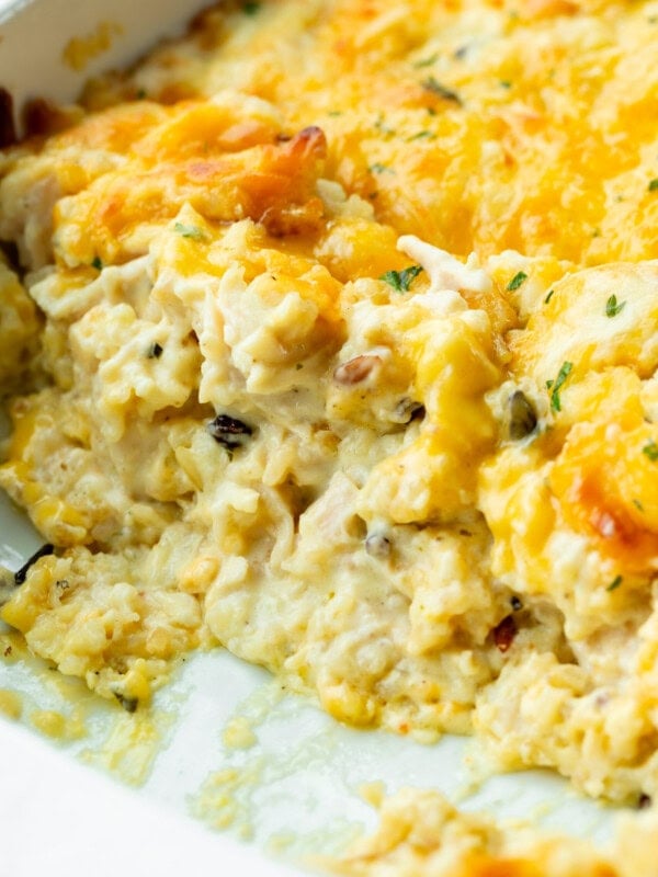 a photo of creamy chicken and rice casserole topped with melted cheese