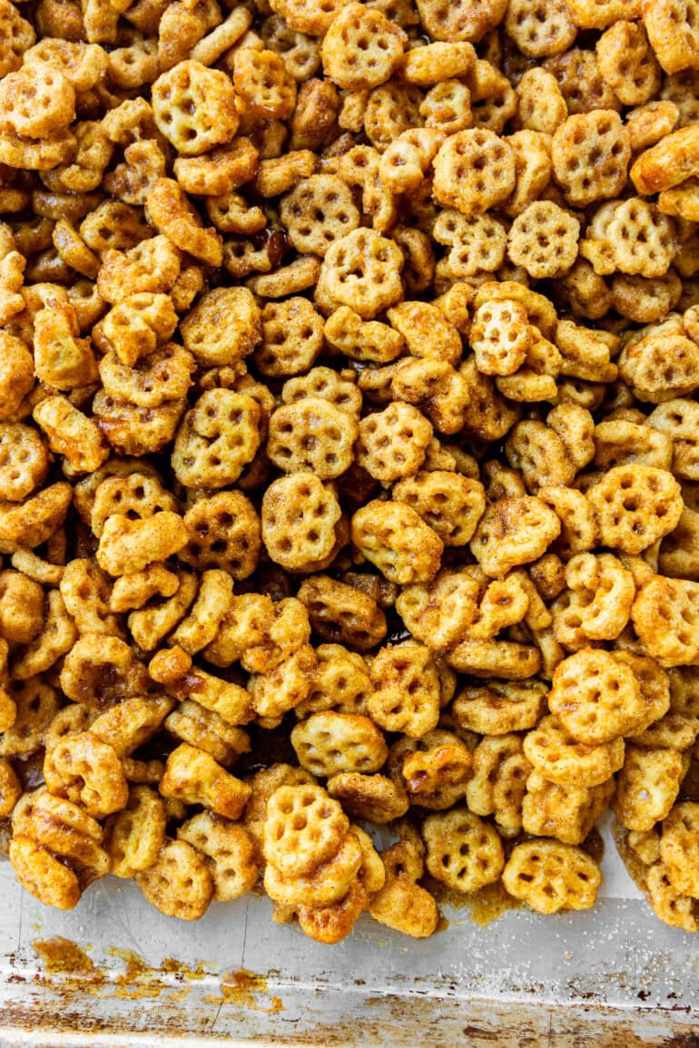 a photo of a baking sheet covered in caramel and cinnamon sugar coated honeycomb cereal