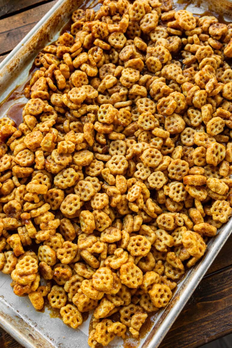 a photo of a sheet pan filled with caramel coated honeycomb cereal covered in cinnamon sugar