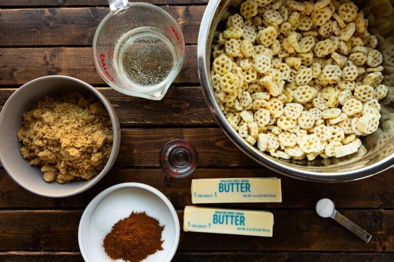 a photo of all the ingredients for churro snack mix including honeycomb cereal, butter, brown sugar, cinnamon and karo syrup