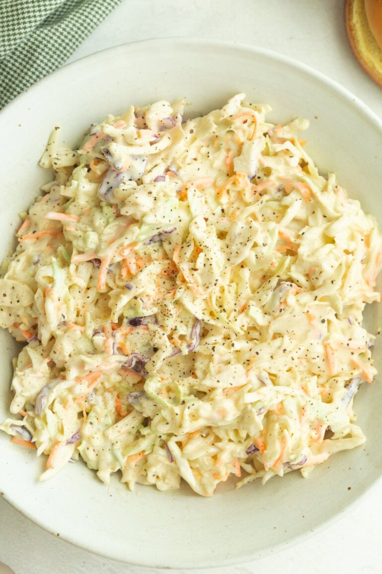 Cold and creamy cabbage slaw loaded with fresh vegetables and tossed in a tangy, slightly sweet mayo-based sauce.