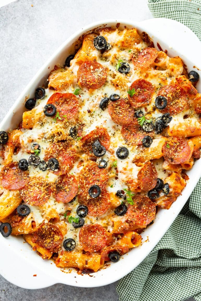 Photo of casserole dish filled with baked pizza pasta casserole