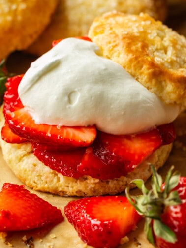 a photo of a golden sweet biscuit filled with juicy strawberry slices and fluffy whipped cream