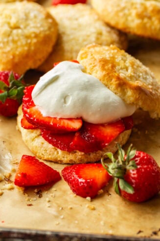 a photo of a golden sweet biscuit filled with juicy strawberry slices and fluffy whipped cream
