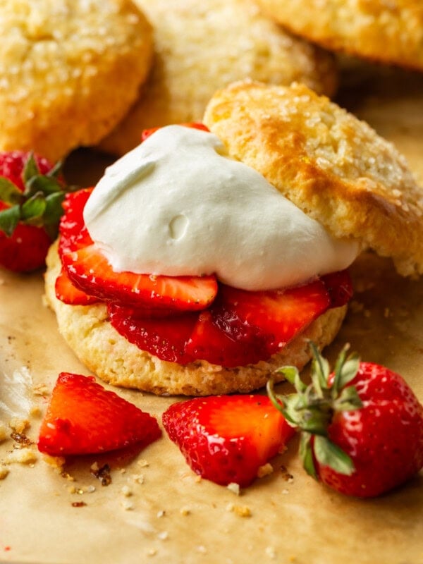 a photo of a golden sweet biscuit filled with juicy strawberry slices and fluffy whipped cream