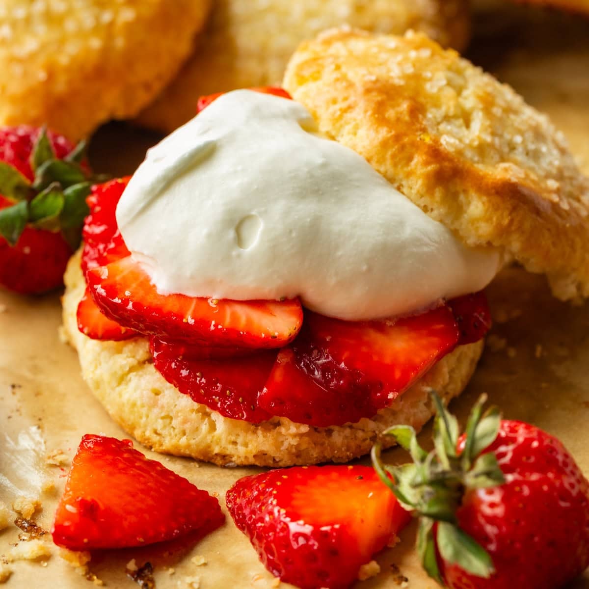 a photo of a golden sweet biscuit filled with juicy strawberry slices and fluffy whipped cream