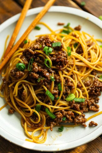 a photo of saucy ground beef tossed with cookie spaghetti topped with sliced green onions