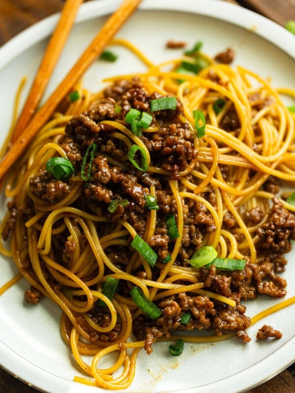 a photo of saucy ground beef tossed with cookie spaghetti topped with sliced green onions