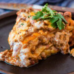 This is so good!!! One skillet enchilada casserole is loaded with saucy ground beef, gooey cheese and lots of flavor! It's our family's new favorite easy dinner recipe! ohsweetbasil.com