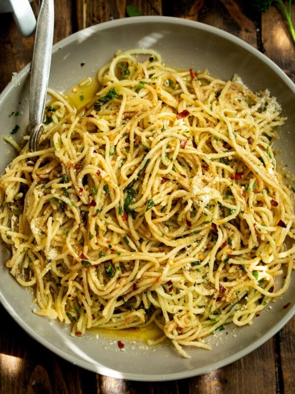 a photo of a large plate full of cooked spaghetti pasta tossed with hot oil and herbs