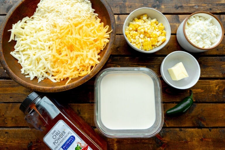 Ingredients for A cheese dip including cheddar, Chihuahua cheese, Monterey Jack, and sweet corn for the perfect appetizer.