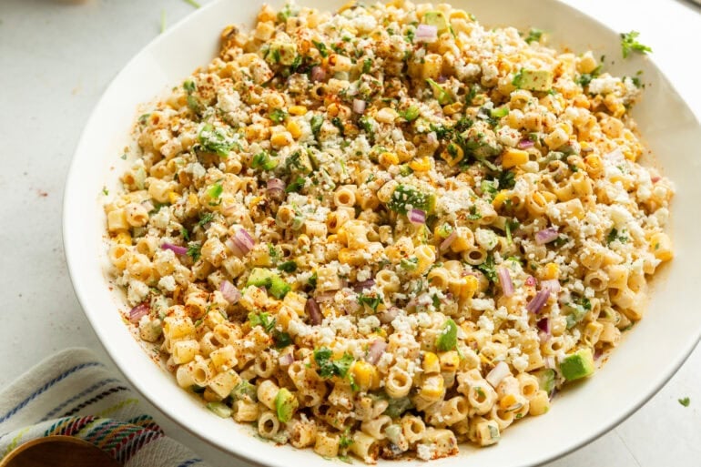 a large bowl of creamy mexican street corn pasta salad