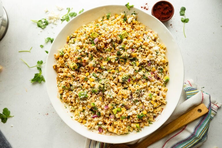 a large serving bowl of creamy mexican street corn pasta salad
