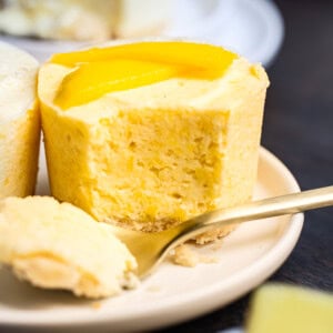 a small frozen mango pie with a fork removing a bite so you can see the cross section of the pie