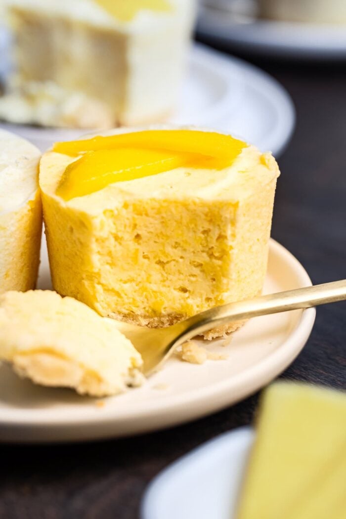a small frozen mango pie with a fork removing a bite so you can see the cross section of the pie