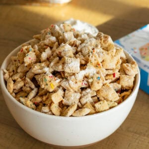 a small bowl of cake mix muddy buddies mixed with rainbow sprinkles