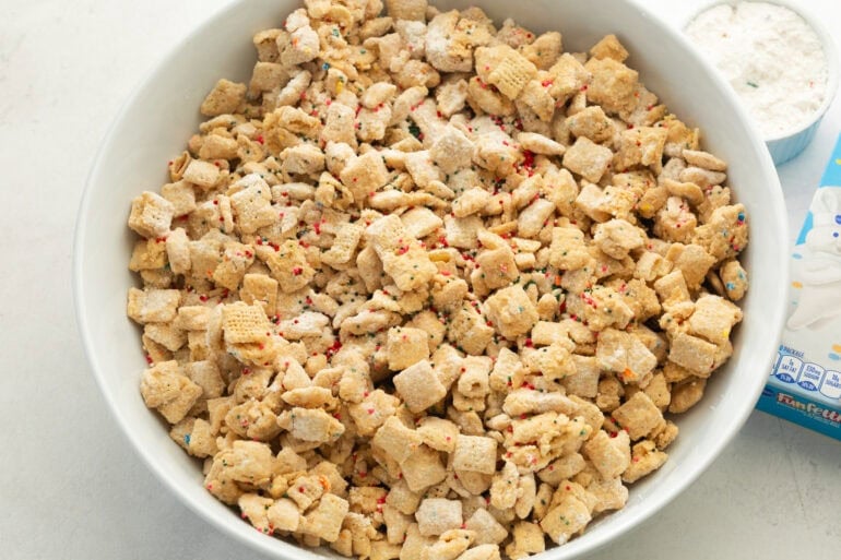 a large white serving bowl of funfetti puppy chow