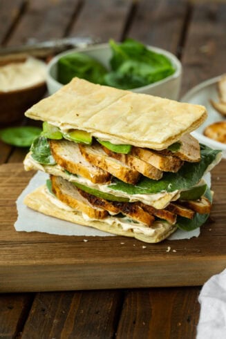a photo of a double stacked grilled chicken and avocado napoleon sandwich