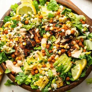 a large wooden bowl full of grilled chicken salad with southwest ranch dressing