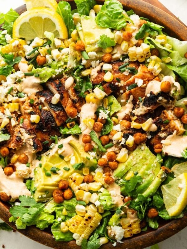 a large wooden bowl full of grilled chicken salad with southwest ranch dressing