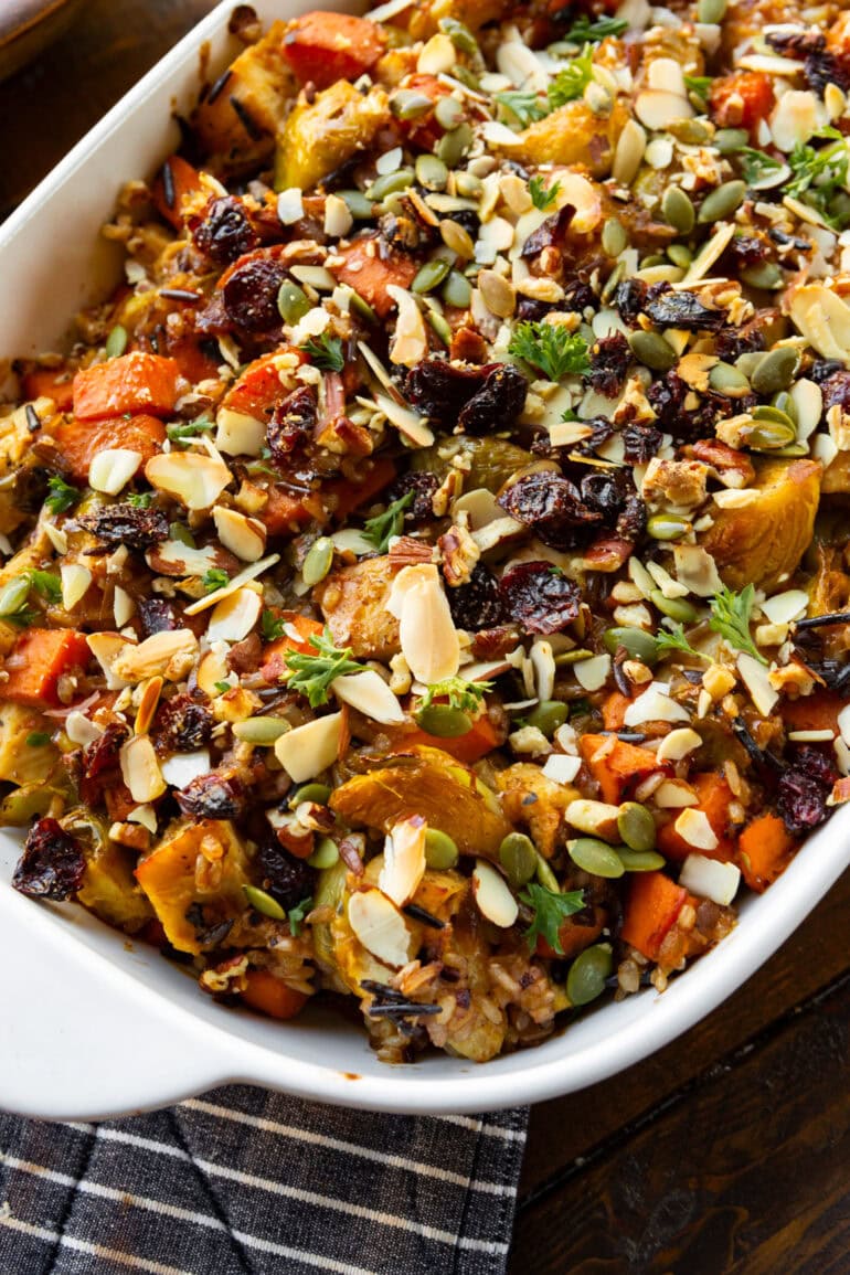 a photo of a white baking dish full of a colorful harvest chicken casserole