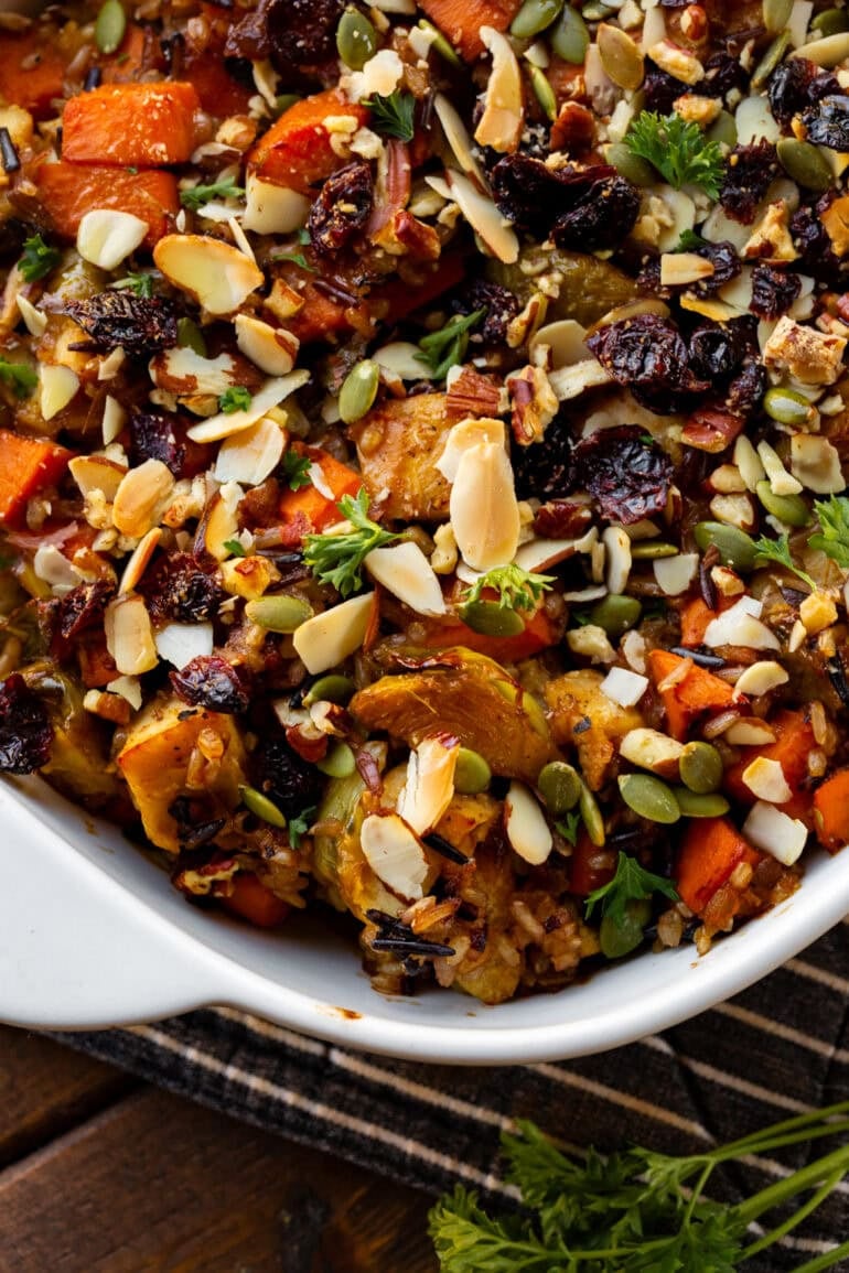 a photo of a baked harvest chicken casserole in a white baking dish