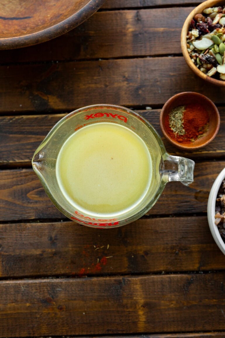 a photo of a glass measuring full of honey mustard dressing