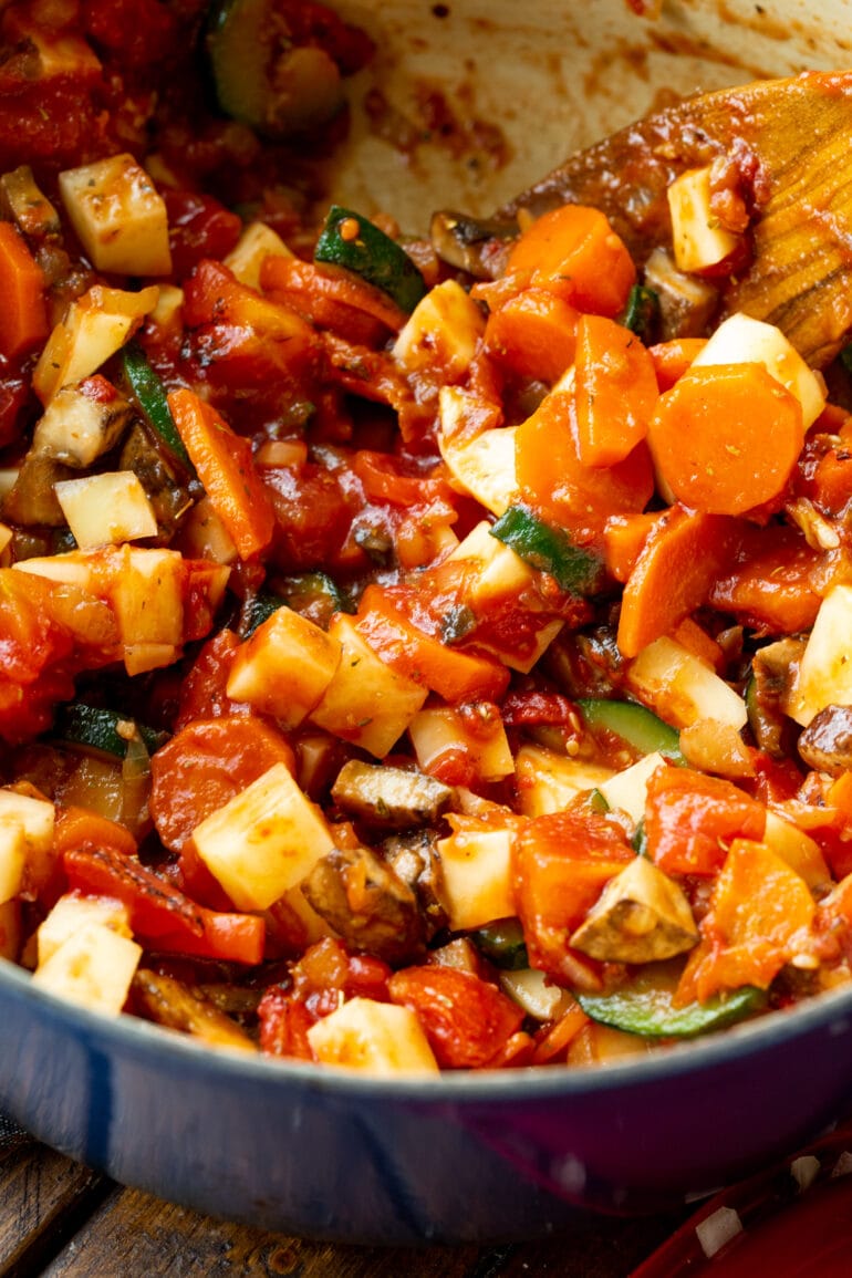 a photo of all the veggies for ham and vegetable soup simmering in a dutch oven pan