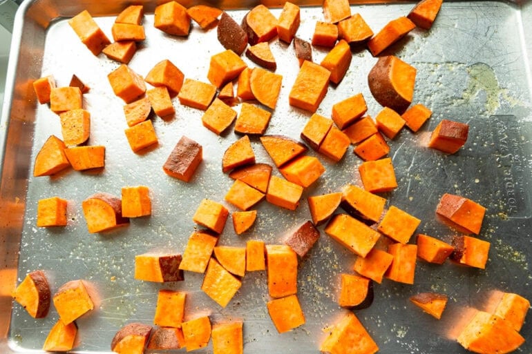 a sheet pan with cubed roasted sweet potatoes on it