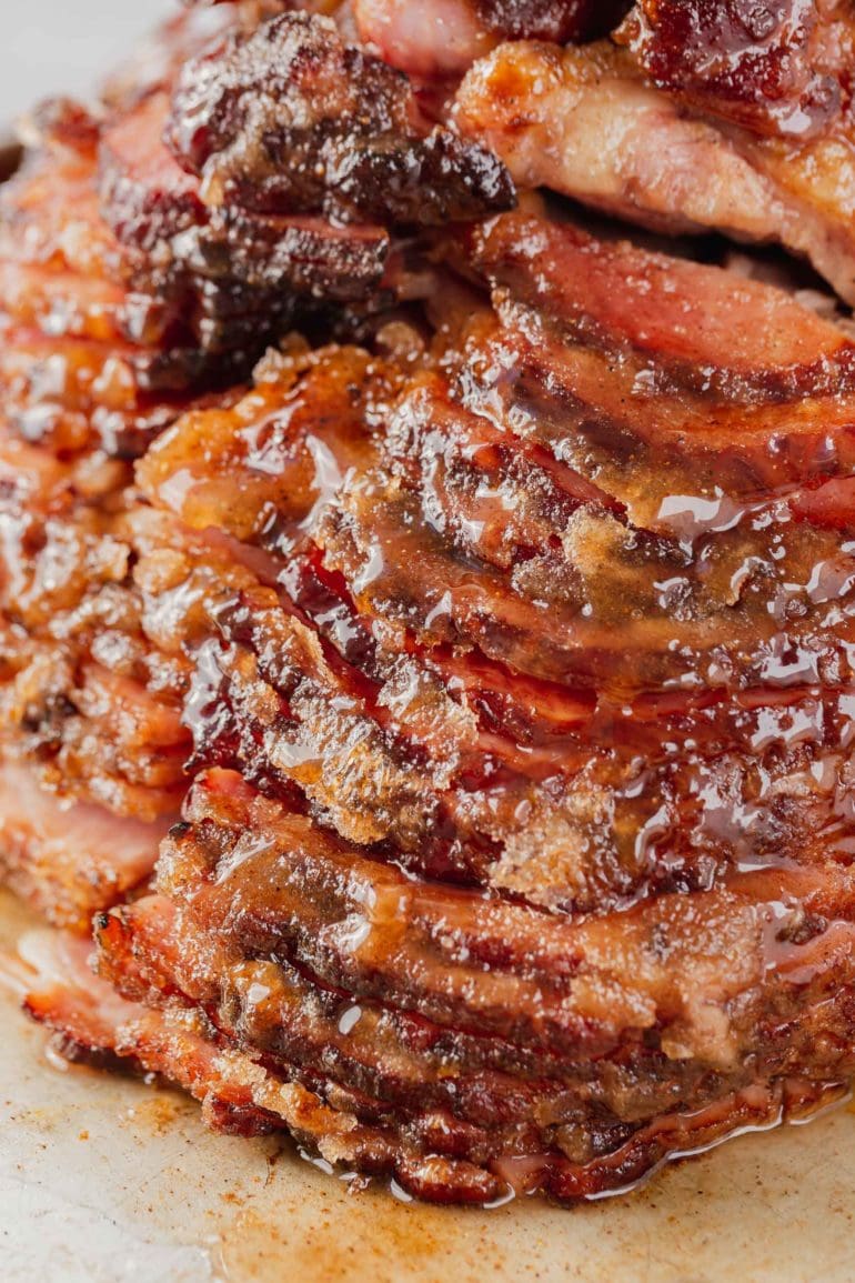 A close-up picture of a honey baked spiral cut ham. You can see the glaze on the ham.