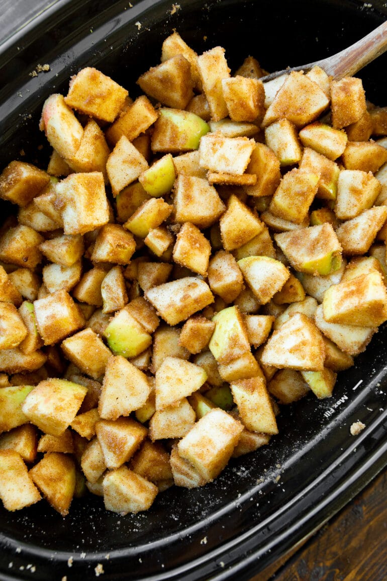 chunks of apple coated in warm spices in a crockpot