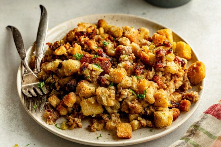 Buttery and herby crockpot stuffing recipe on a large serving plate

