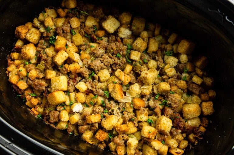 A slow cooker filled with savory doctored up crockpot stuffing recipe for Thanksgiving dinner