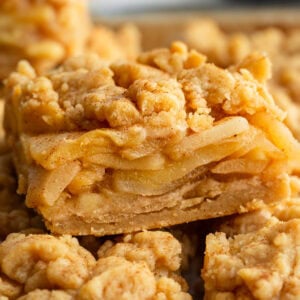 slice of apple pie bar showing layers of cinnamon apples