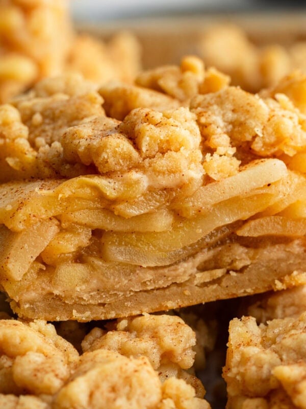 slice of apple pie bar showing layers of cinnamon apples