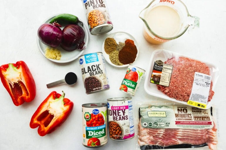 all the ingredients for the best instant pot chili with ground beef, bacon, black beans, pinto beans, fire roasted tomatoes, onions, red bell pepper, and spices