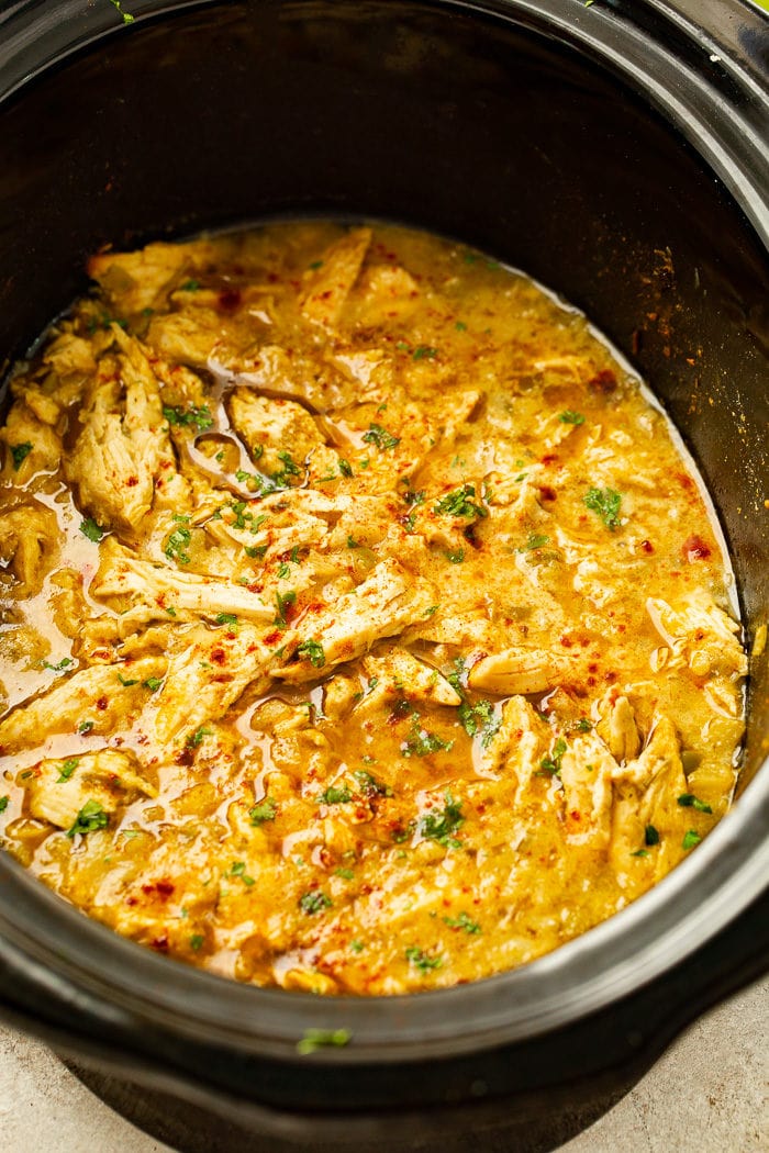 Crockpot filled with shredded Mexican chicken and pineapple