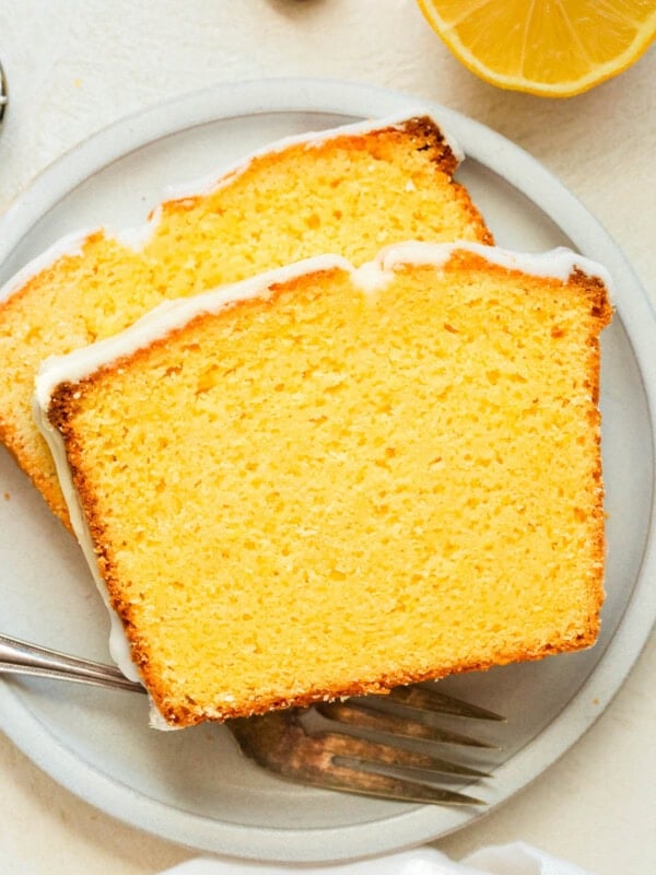 a photo of two slices of lemon pound cake sitting on a small dessert plate