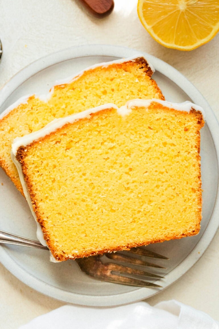 a photo of two slices of lemon pound cake sitting on a small dessert plate