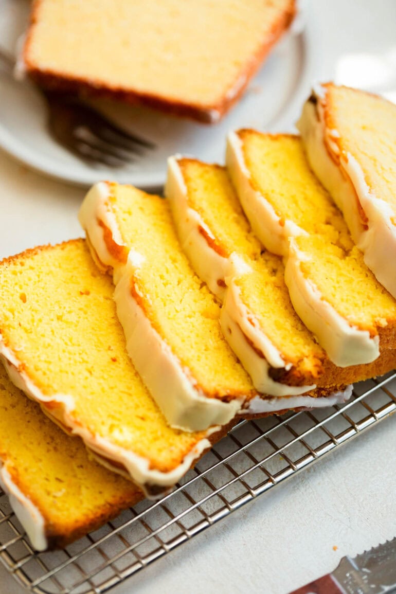 A photo of lemon pound cake sliced on a wire cooling rack