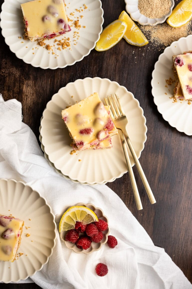 lemon raspberry bars sitting on small dessert plates