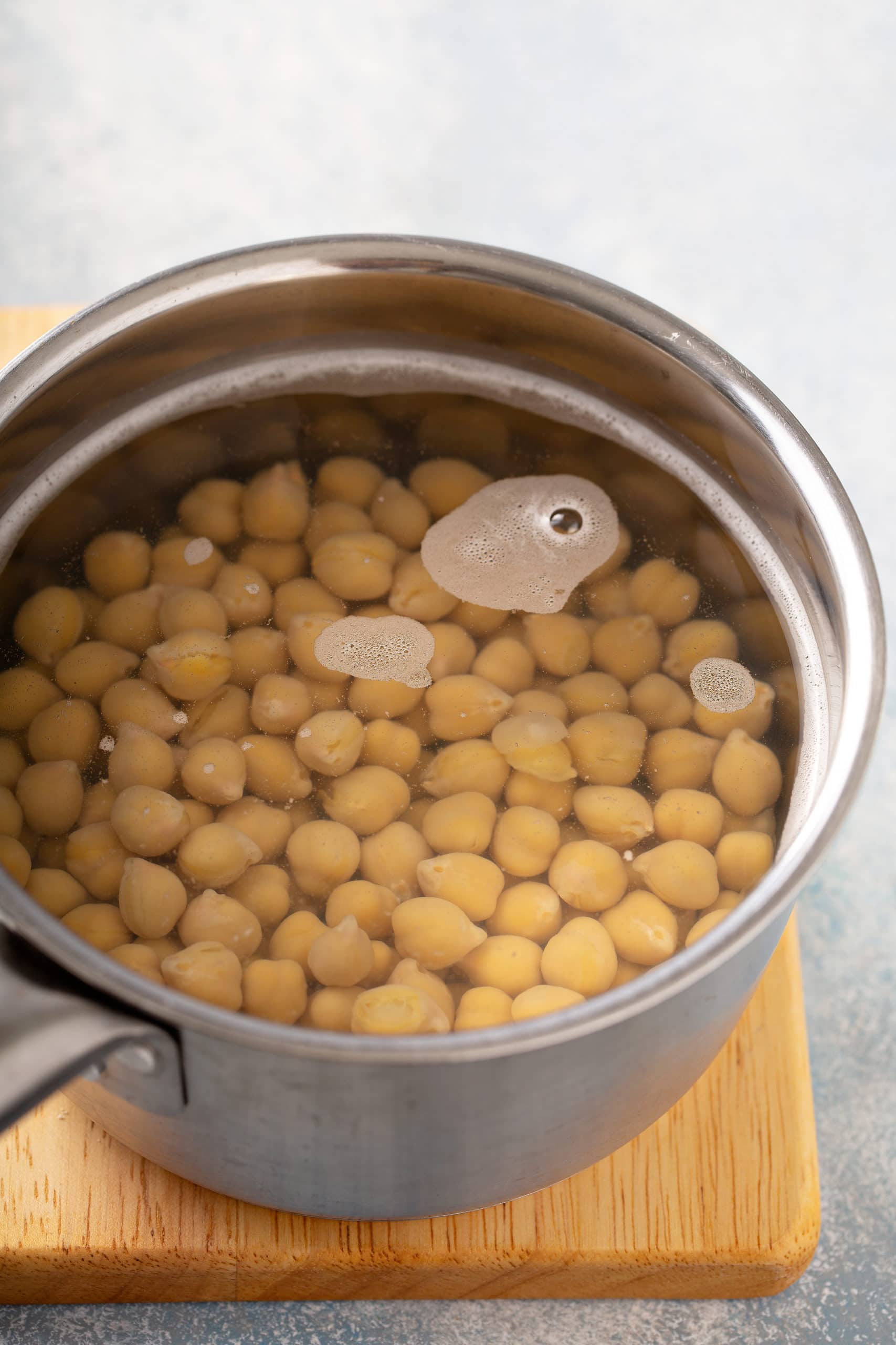 A pan with chick peas covered with water.