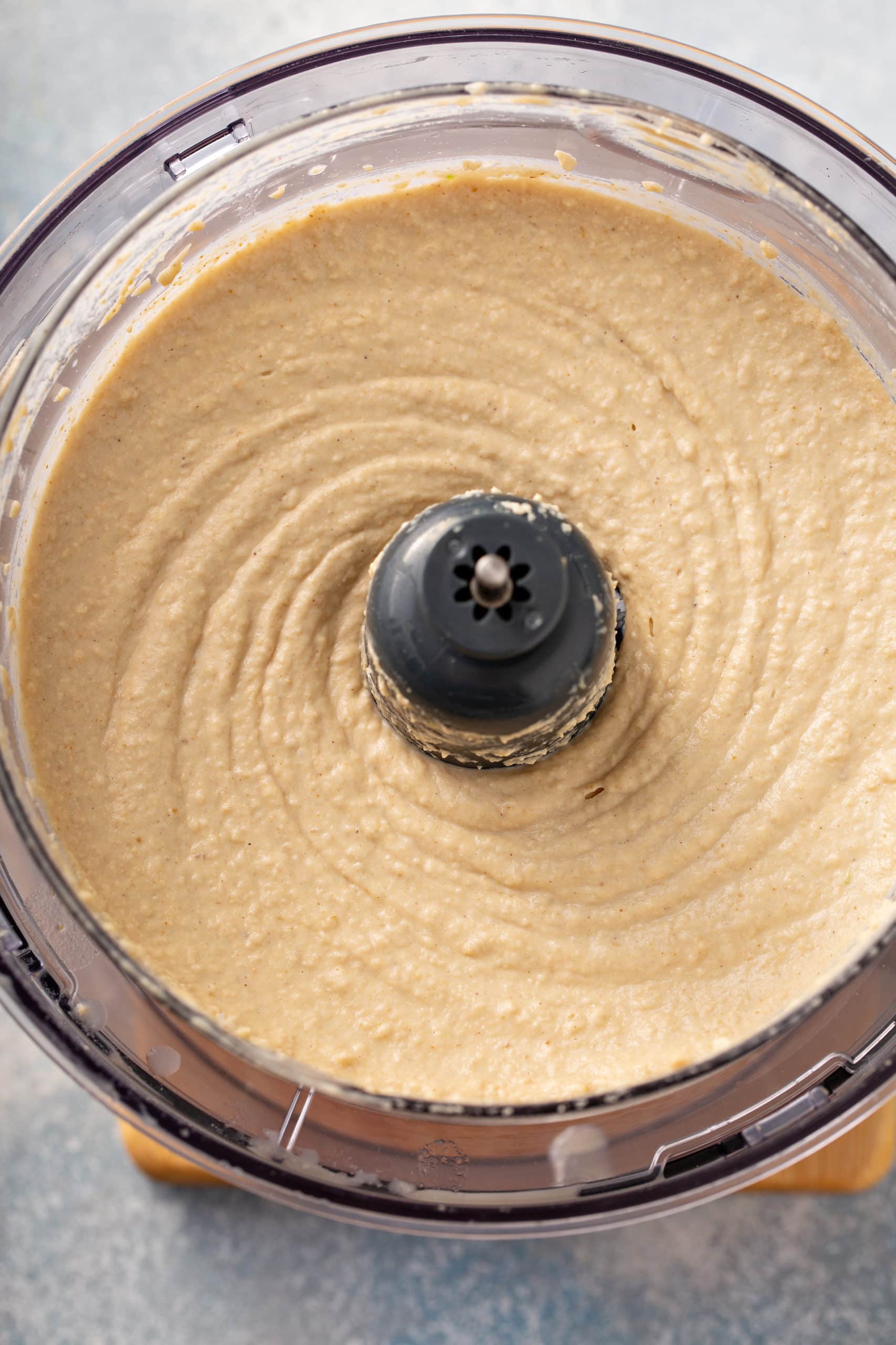 Best Easy Homemade Hummus A food processor filled with smooth, creamy hummus.