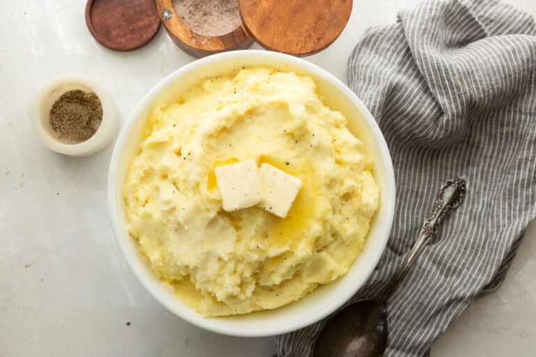 creamy make ahead mashed potatoes topped with melted butter